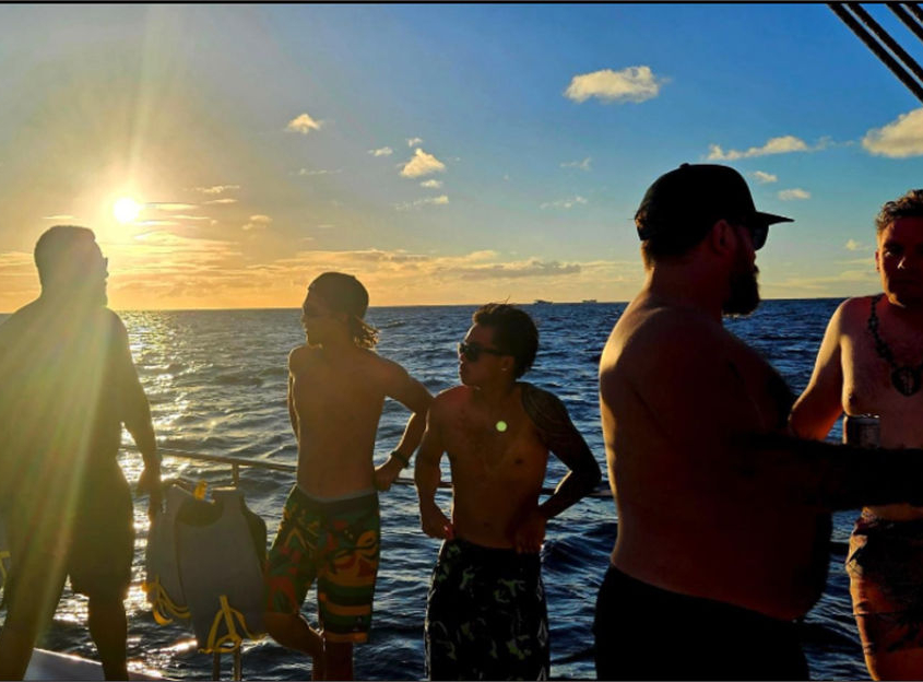 Guys on the boat at sunset